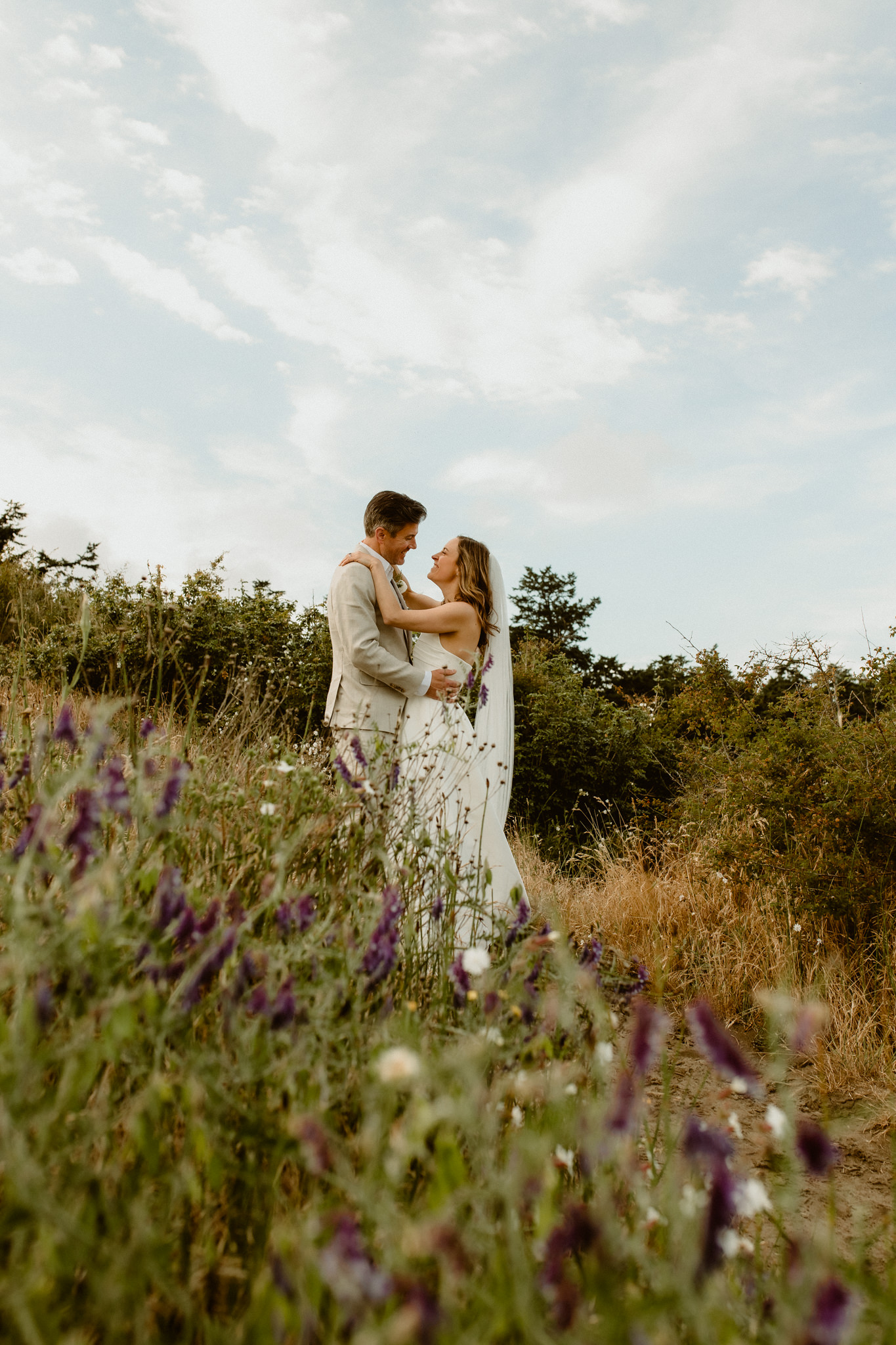 Whidbey Island elopement couple with wildflowers overlooking Ebey's Landing